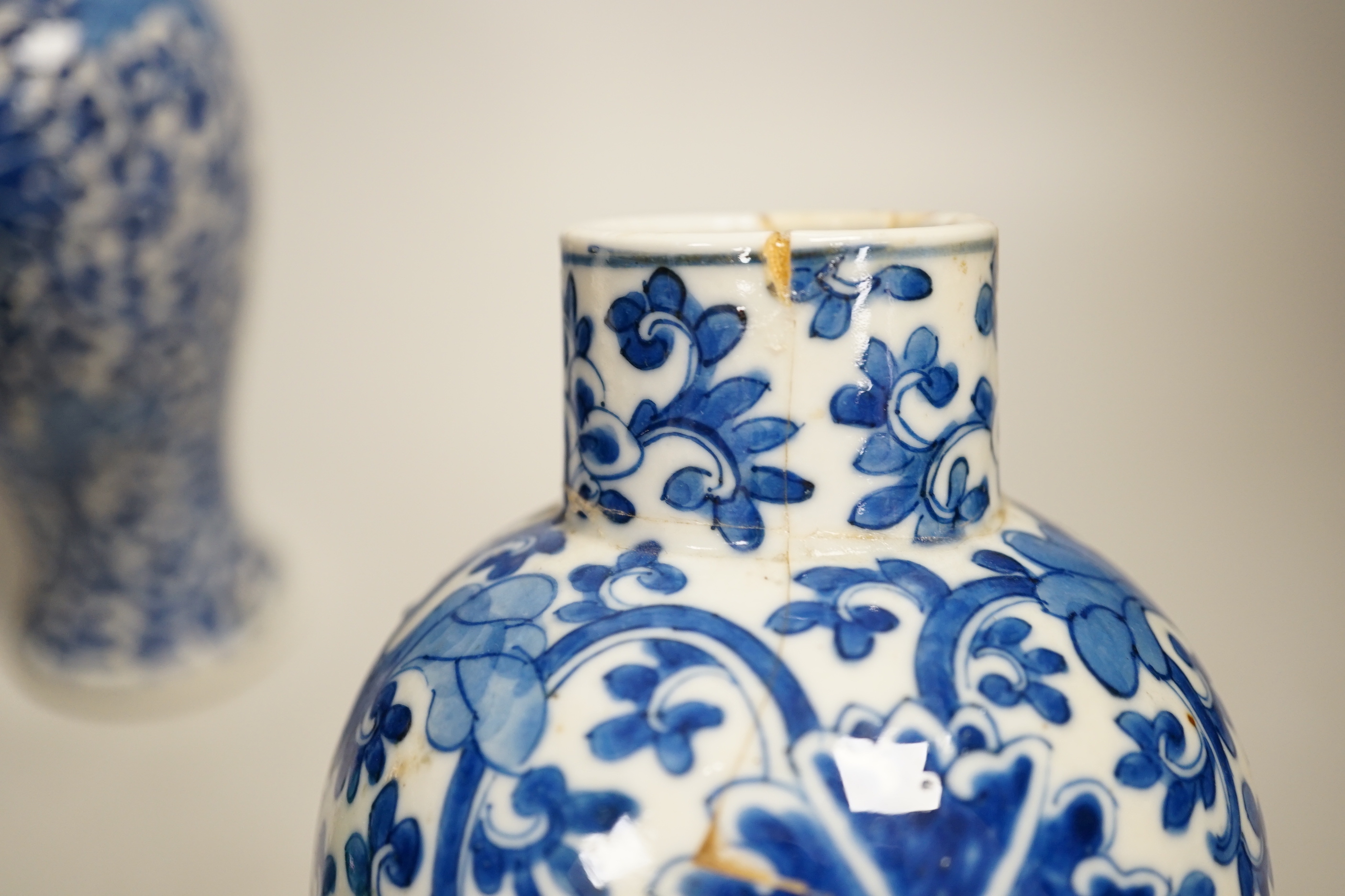 A pair of Chinese blue and white vases and a green glazed vase, blue vases 22.5cm high